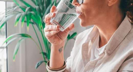 Female drinking from a glass of water. Health care concept photo, lifestyle, close up