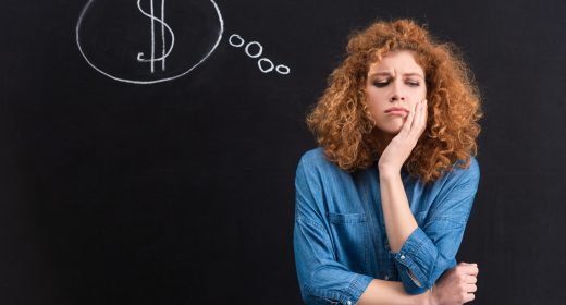 sad redhead girl with dollar sign in thought bubble on chalkboard sad redhead girl with dollar sign in thought bubble on chalkboard